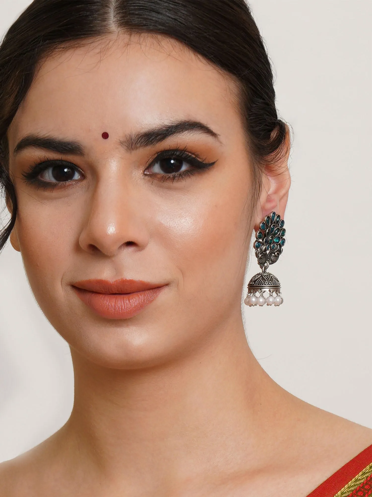 Karatcart Oxidised Silver Peacock Shape Green Stone Studded Jhumki Earrings for Women
